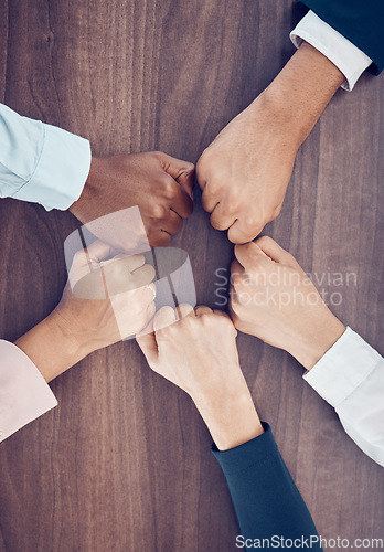 Image of Fist, above and employees meeting with support, partnership and solidarity together at work. Hands of corporate, diversity and motivation from workers in a team for business and goal on a table