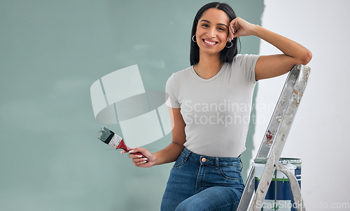 Image of Painting, wall and woman doing home renovation, design and maintenance in room of her house. Happy, portrait and painter with smile, mockup and paint for home improvement and renovation on her home