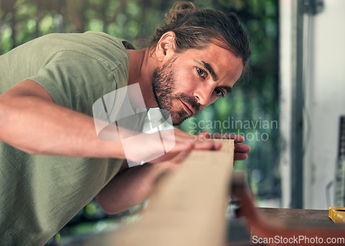 Image of Carpenter, thinking or checking wood in workshop, small business garage or creative manufacturing factory. Lumber worker, diy man or carpentry designer with furniture, table or desk production ideas