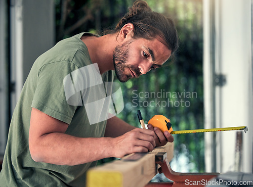 Image of Carpenter, builder and diy for home improvement, development and repair with concentration in house. Man, wood and measure in home with pencil, measuring tape and focus for renovation of interior.