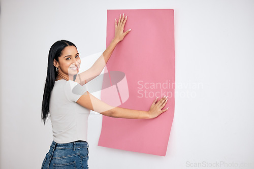 Image of Woman, wall and wallpaper with smile in house for color, change or texture in room, home or room with happiness. Happy, creative or designer with paper, pink or interior design for renovation at work