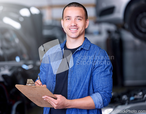 Image of Man, clipboard writing and mechanical engineer in workshop, car manufacturing industry and car garage. Portrait, smile and happy motor production worker with repair schedule or export parts documents