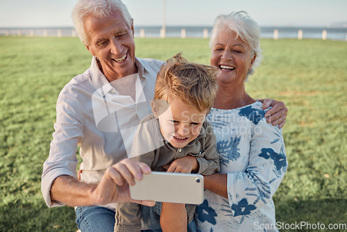 Image of Happy family, grandparents and child take a selfie in nature with a phone camera for bonding memories outdoors. Smile, old man and elderly woman laughing with an excited young kid on holiday vacation