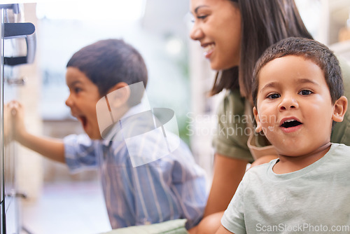Image of Mom, kids and oven in kitchen for baking, cooking or cake in home with happy, excited and smile on face. Mother, boy and children in house for preparation of cookies, food or muffin in Los Angeles