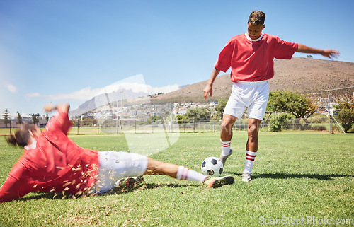 Image of Men, soccer and slide tackle in sports fitness, training and exercise on the field outdoors. Athletic man tackling football player in sport for control, possession or defense in game or match outside