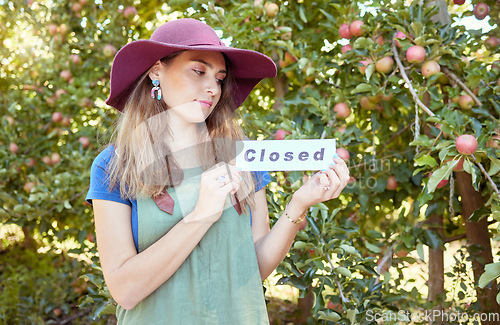 Image of Woman farmer, closed sign and apple farm, agriculture worker and sustainability business. Farming employee with icon or board for advertising end of fruit garden collection season or work day outdoor