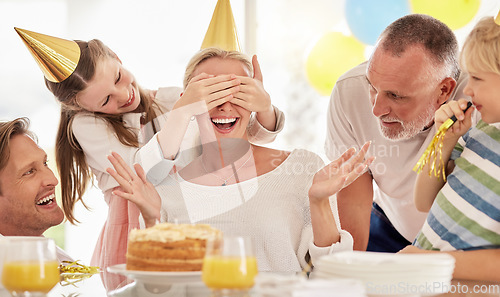 Image of Surprise, birthday cake and mother with family for celebration, party and excited people. Happiness, love and big family with children cover mom eyes to celebrate mothers day holiday together