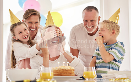 Image of Surprise, mother birthday and family celebrate at a party at home with a happy smile. Mama, father and children with happiness and excited joy in a house with event food, cake and candles for mom