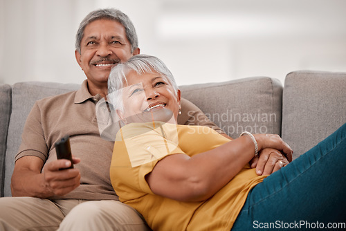 Image of Happy senior couple, love and watching tv relax together on living room sofa at family home. Elderly married man and woman, chill and watch television on couch bonding, laughing and smile at movie