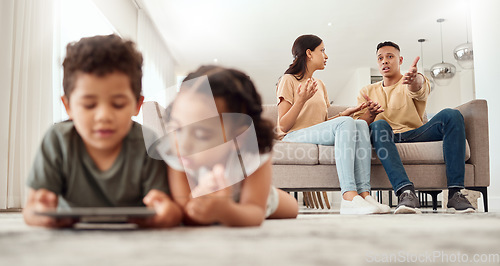 Image of Mother, father and disagreement on living room sofa while children are playing with tablet on the floor at home. Mama and dad fighting, argue or conflict in difficult situation on couch in dispute