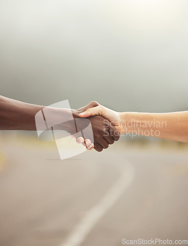 Image of Handshake, success and hands with diversity, support and teamwork partnership on a road. Hand together of friends, workers or people showing motivation solidarity, faith trust and hope outdoor