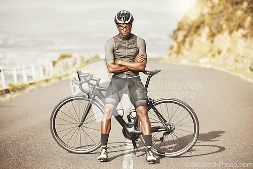 Image of Black man, cycling and mountain bike with arms crossed for sports exercise, training and fitness in nature. Portrait of a confident African American male professional on a bike cycle tour outdoors