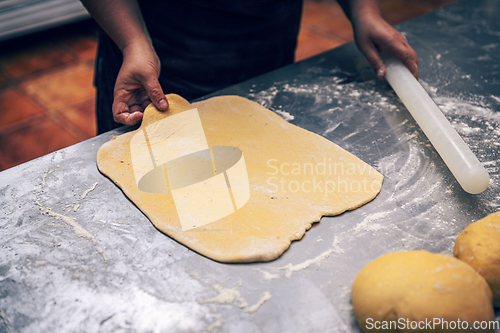 Image of Woman's hands roll the dough