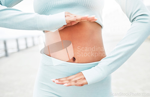 Image of Fitness, woman and hands on stomach for digestion health with workout, exercise and training. Gut health, weight loss or diet of active runner girl showing healthy abdomen on cardio break.