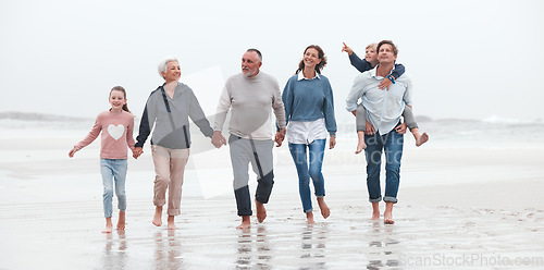 Image of Family, beach and children with grandparents, parents and kids walking in the water on the sand in a summer holiday. Travel, love and vacation with a girl, boy and relatives taking a walk by the sea