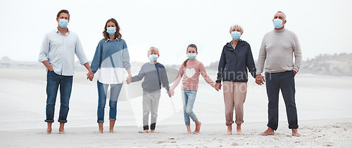 Image of Covid, walking and family at the beach with face mask on, holding hands with grandparents, parents and children. Big family on a walk, stroll and relax by the ocean after covid 19 pandemic lockdown