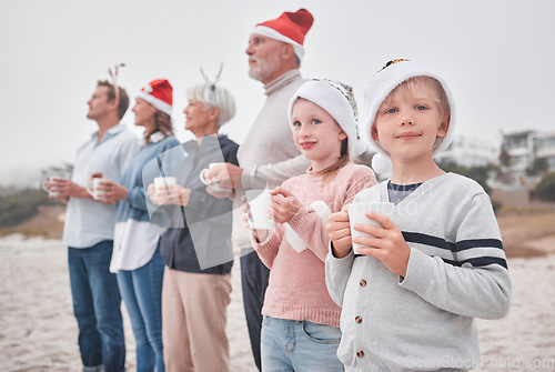 Image of Love, Christmas and freedom for happy family at the beach drinking eggnog, coffee or tea on big family vacation. Festive quality time for grandparents, parents and kids bonding on Amsterdam holiday