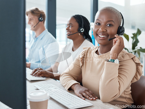 Image of Call center, customer service and crm with a black woman consultant working with her team in the office. Contact, ecommerce and contact us with a female telemarketing employee at work with colleagues