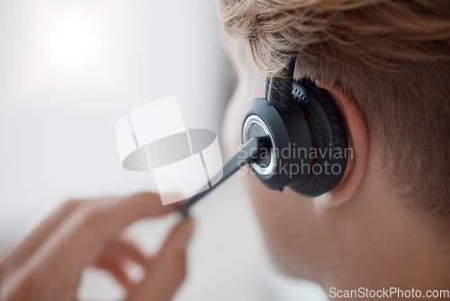 Image of Closeup, headset in call center with woman, consultant or telemarketing in office. Contact us, crm or consulting in customer service, help or customer support with zoom of microphone for call