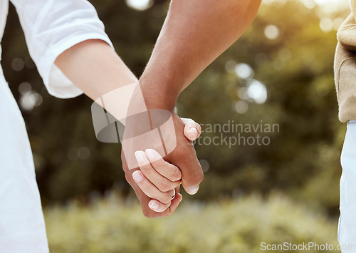 Image of Diversity, holding hands and couple being romantic, support and being together for relationship, marriage and unity. Multiracial, hand gesture and interracial for romance, outdoor holiday and union.