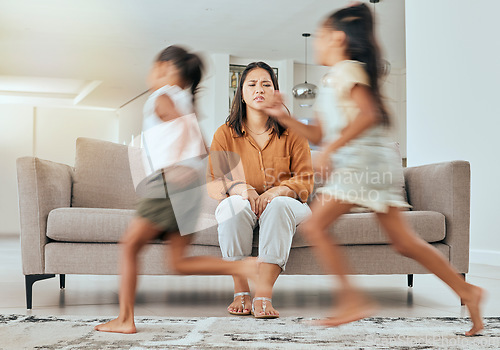 Image of Child care stress, mother and children running with energy with mom feeling anxiety on a home sofa. Mama burnout, kids and fast siblings run in the living room lounge with tired mom on the couch