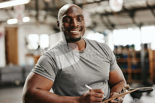 Image of Gym, documents or black man writing on clipboard for membership, sign up or checklist for sport health or workout. Wellness coach, fitness or happy personal trainer, paper for exercise schedule