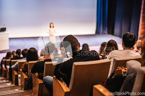 Image of Woman giving presentation on business conference event.