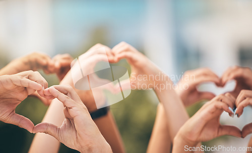Image of Crowd, hands and heart sign with group of people, community and friends with emoji for care, freedom and health outdoor. Fans, concert and support of men and women on solidarity for charity thank you