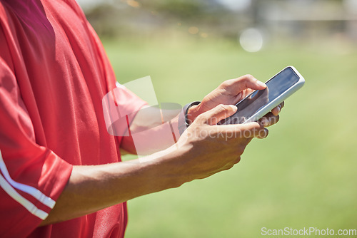 Image of Strategy, tactics and coach with phone to educate, teach and inform soccer players to win a competitive football game. Modern sports coaching, digital tracking and match performance analytics