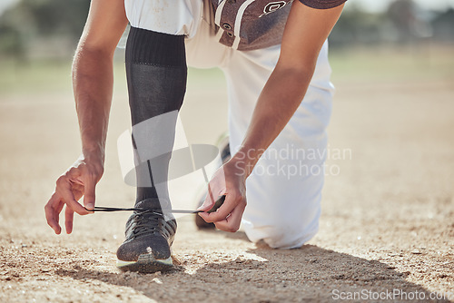 Image of Baseball, sports and athlete tie laces of shoes to prepare for a match or training on an outdoor field. Softball, sneakers and active man getting ready for a game or practice on a sport pitch.