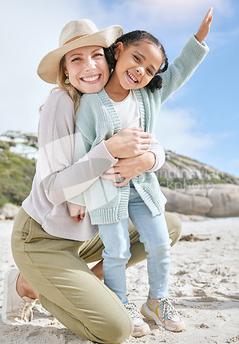Image of Love, mother and girl on beach, bonding and relax for holiday vacation and outdoor together. Mama, daughter and happy kid with smile, embrace and hug on seaside sand, in summer and adventure travel.
