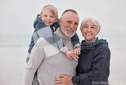 Image of Family, portrait and child with grandparents at a beach, hug, relax and smile while having fun on vacation. Travel, happy family and senior couple enjoy ocean trip and quality time with grandchild