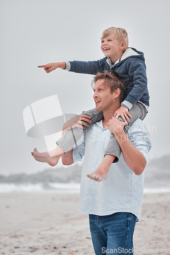 Image of Father, child and piggyback pointing on the beach for walking, bonding and quality time together in the outdoors. Dad, kid and shoulder ride by the ocean for fun walk with smile in happiness outside