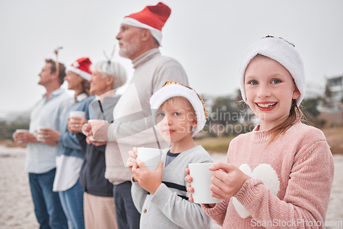 Image of Family, generations and Christmas, drink and view outdoor while on vacation, holiday and festive time at the beach. Parents, grandparents and children, happy with hot chocolate, mug and xmas hat.