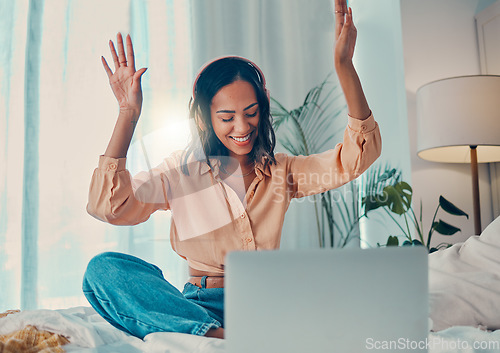 Image of Happy woman, laptop and listening to music using headphones, internet and dancing sitting in bedroom apartment for fun. Female, energy dance and streaming online with wifi technology to relax at home