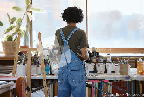 Image of Woman, artist and painter in studio, creative workshop or Indian art gallery for abstract oil design. Thinking, planning or painting person with ideas for exhibition, expo or inspiration canvas class