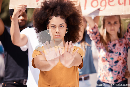 Image of Protest, hands and stop with a black woman activist in demonstration with a group of people ready to fight for freedom. Community, politics and rally with a young female standing against violence