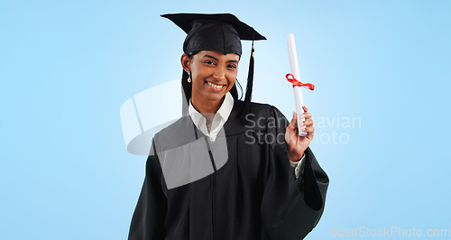 Image of Graduate woman, diploma and portrait in studio with pride, success and achievement by blue background. Graduation, girl and certificate with award, celebration or learning for future from university