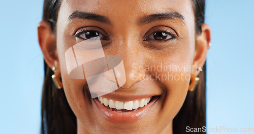 Image of Teeth whitening, dental portrait and woman with smile for oral care, wellness and mouth on blue background. Beauty, hygiene and orthodontics with skin, cosmetics and healthy in studio with veneers