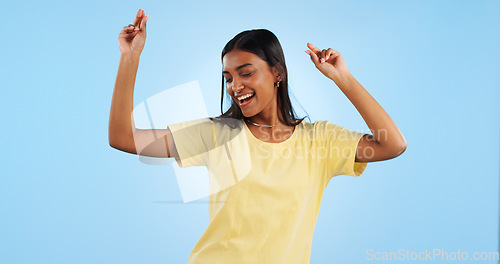 Image of Dance, woman and studio with freedom, smile and happy with modern fashion and fun in studio. Blue background, female person model and music with dancer and celebration with confidence and excited