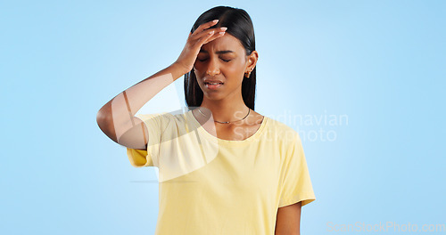 Image of Headache, pain and stress, woman with fatigue in studio with health emergency and wellness on blue background. Migraine, brain fog and vertigo from medical condition with burnout, sick and tired