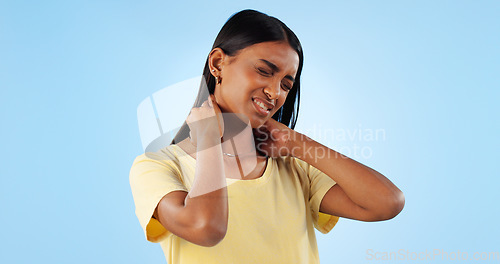 Image of Neck pain, health and woman in studio with spine issue, emergency and bad posture on blue background. Muscle, pressure and fibromyalgia, sick with burnout and injury, mockup space and inflammation