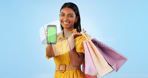 Image of Phone green screen, shopping bag and portrait of happy woman show online discount, sales deal info or studio promo. Tracking markers, cellphone chroma key and mockup space customer on blue background