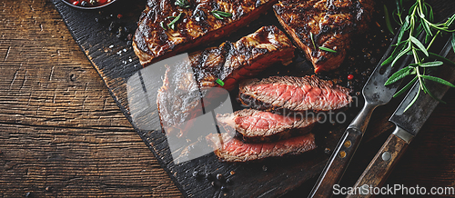 Image of Grilled top sirloin or cup rump beef meat steak on wooden board