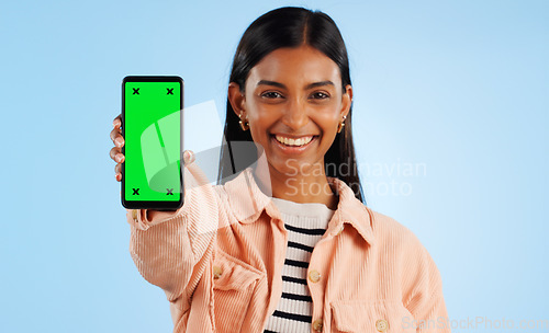 Image of Smartphone green screen, happy portrait and woman show web communication, mobile search engine or app chroma key. Tracking markers, cellphone mockup space and studio tech person on blue background