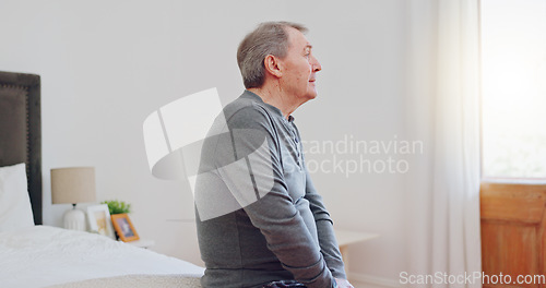 Image of Lonely, senior man and thinking in bedroom with depression, anxiety or mental health in retirement. Tired, elderly person and remember grief or loss in morning, home or sad in the house with a memory