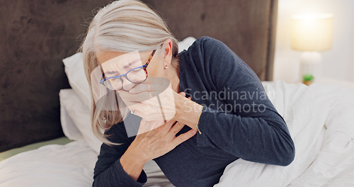 Image of Illness, cough and senior woman in bed with allergies, flu or cold on a weekend morning at home. Sick, chest pain and elderly female person in retirement with asthma or infection in bedroom at house.