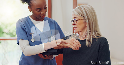 Image of Physical therapy, senior woman and arm injury with stretching at retirement home for wellness and healthy. Medical, worker and caregiver with consultation at clinic with help and chiropractor support