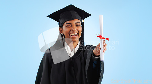 Image of Graduation, certificate and girl in studio portrait for pride, success or achievement by blue background. Graduate woman, diploma or excited for award, celebration or paperwork for future at college