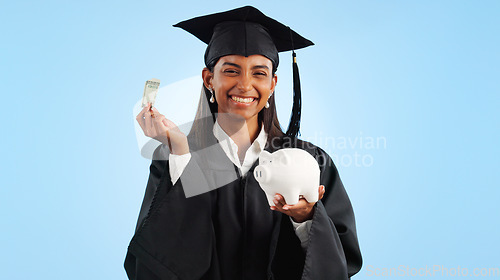 Image of Woman, graduation and piggy bank in studio, money or saving for investing, future or portrait by blue background. Student girl, banking and cash for education, decision or choice for financial plan